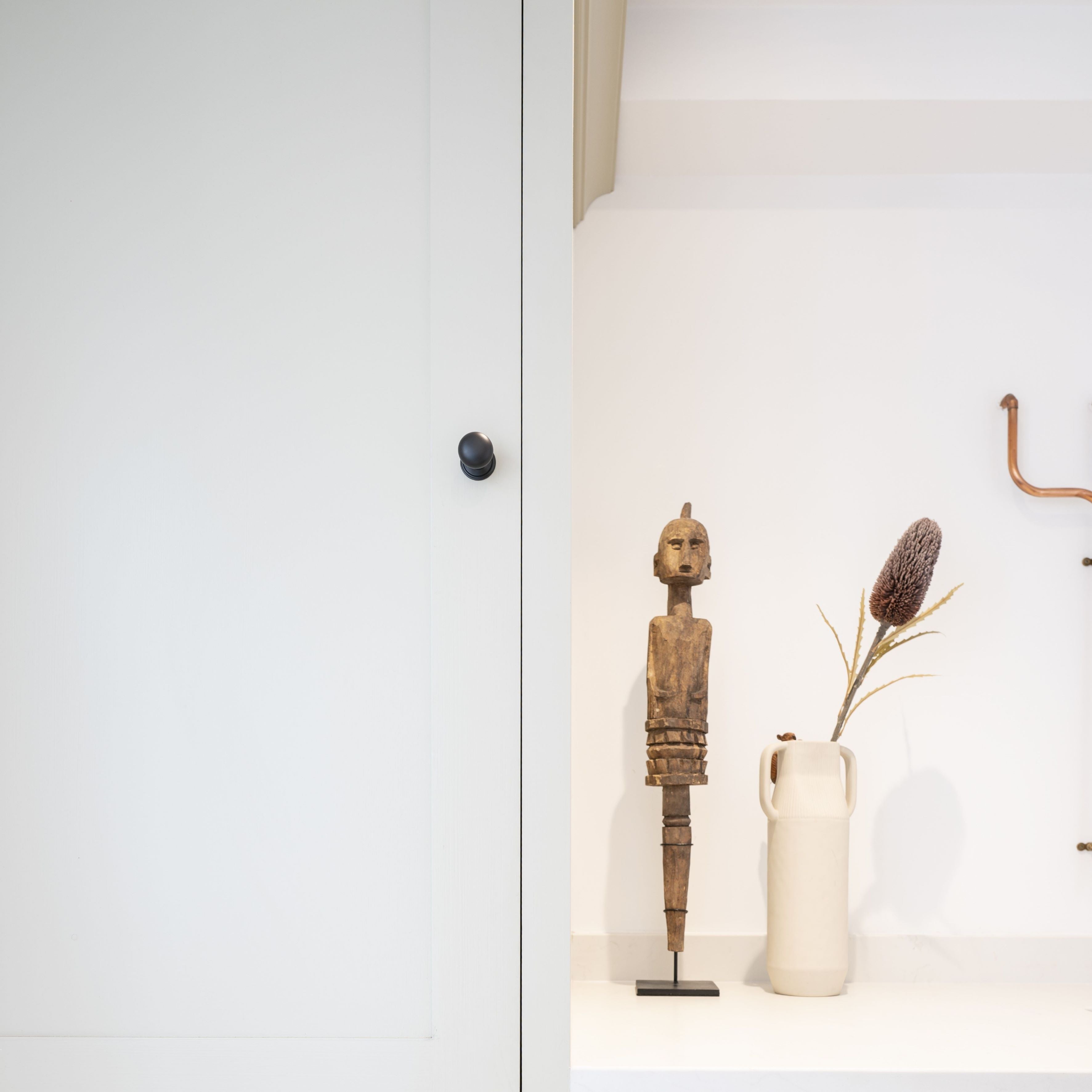From The Anvil Aged Bronze round mushroom cabinet knobs on a white cupboard door