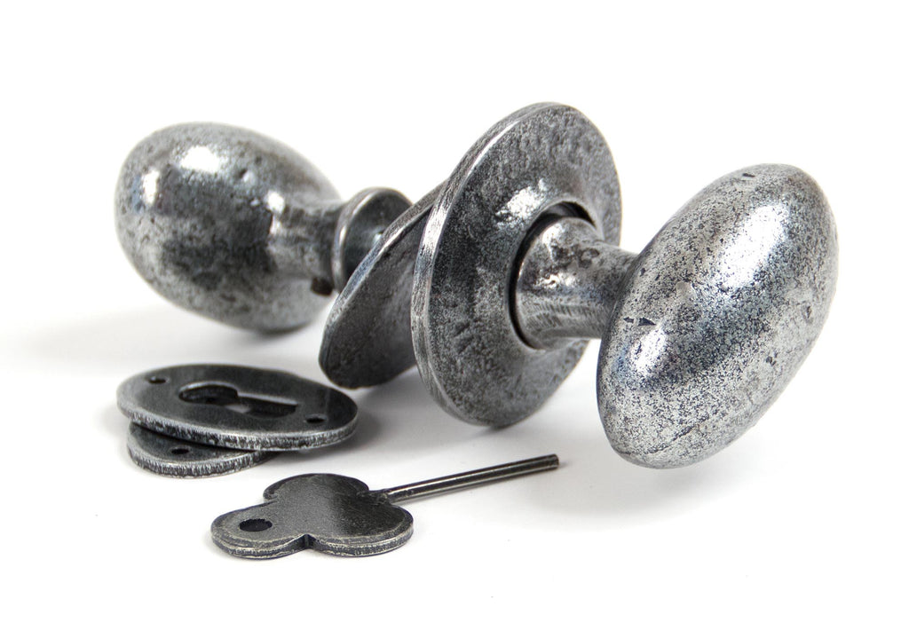 White background image of From The Anvil's Pewter Patina Oval Mortice/Rim Knob Set | From The Anvil