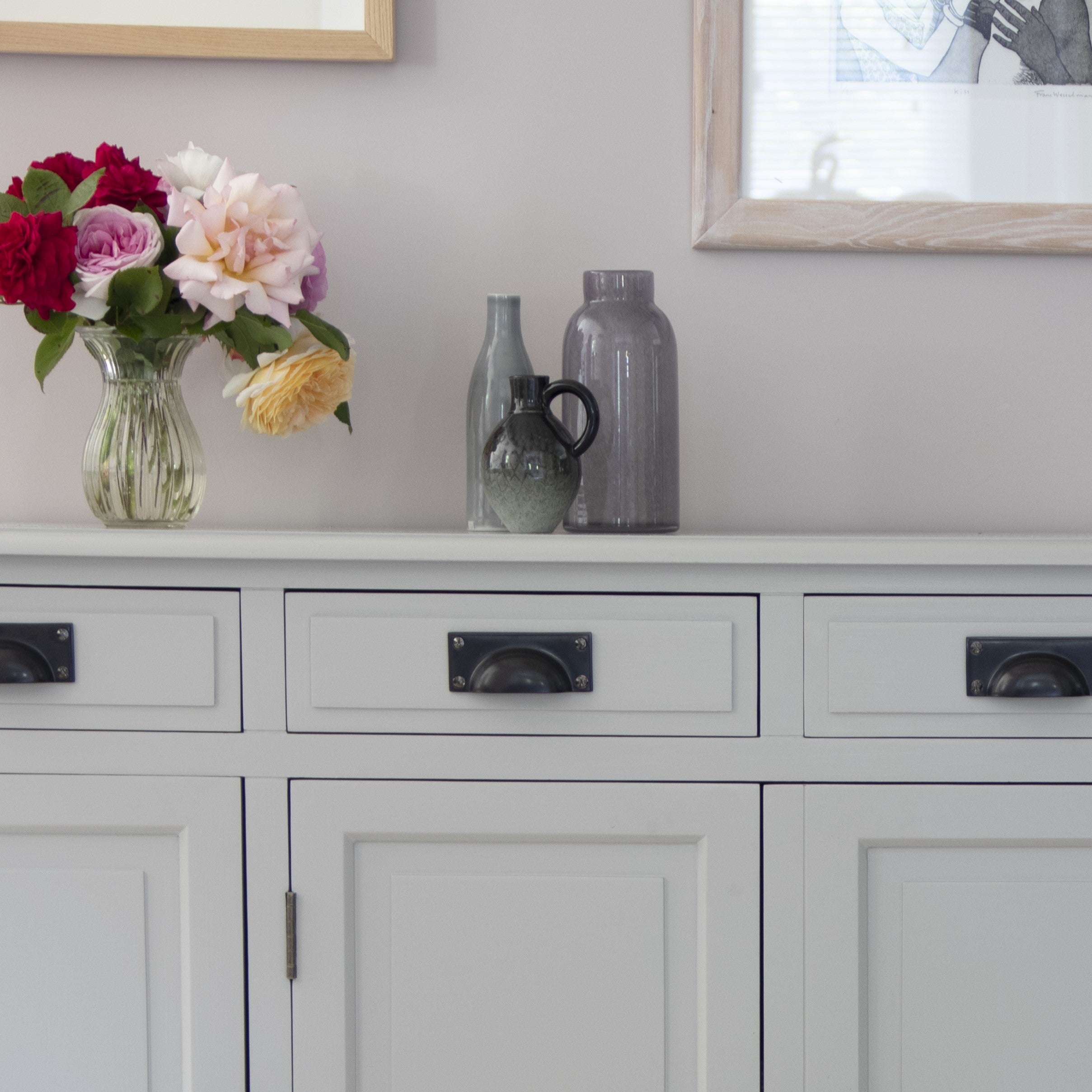 From The Anvil's Agd Bronze Art Deco drawer pull handles on grey painted cupboards.