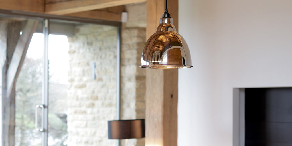 Smooth Brass Brindley ceiling pendant light in a contemporary property.