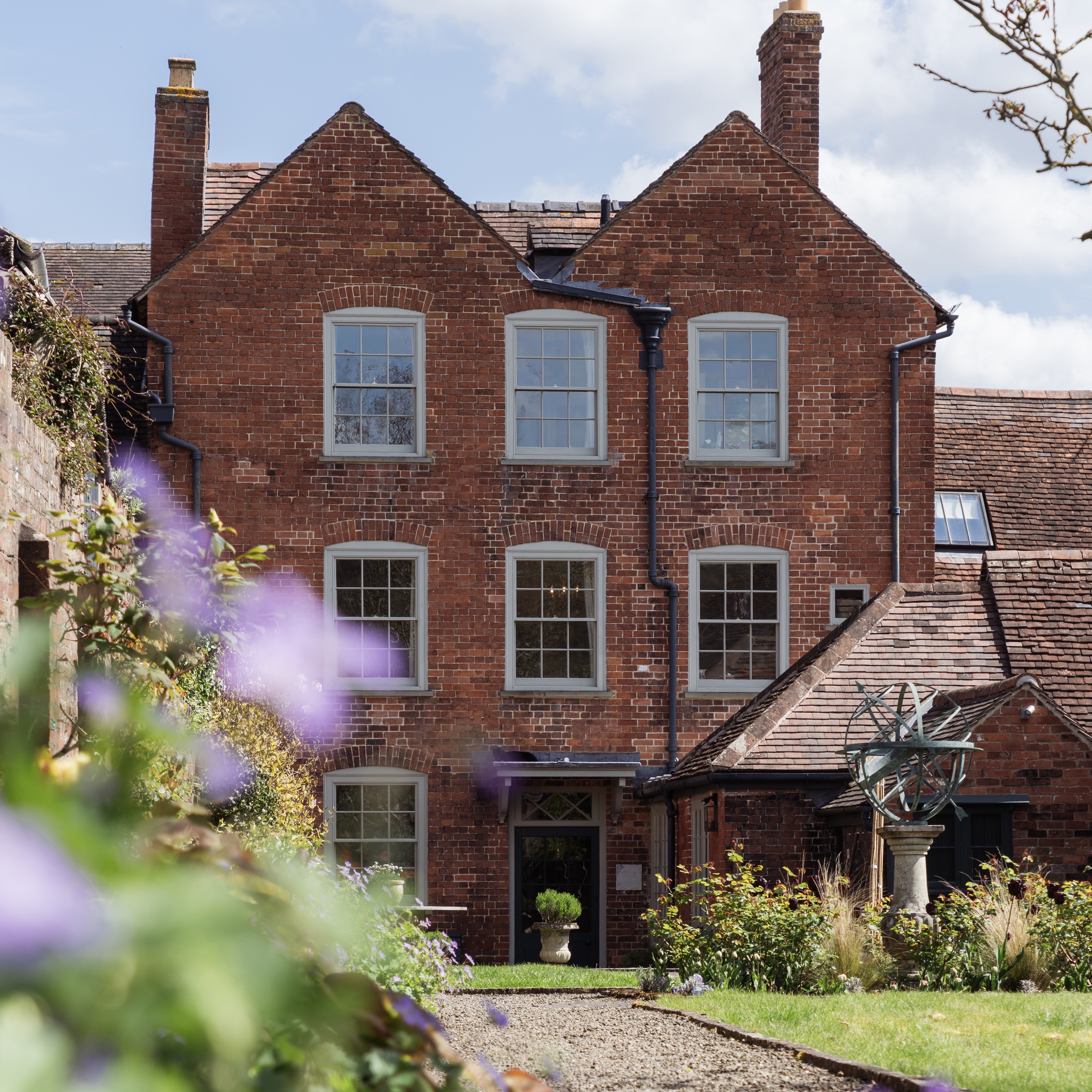 Large, red brick period property with sash windows and a large garden.