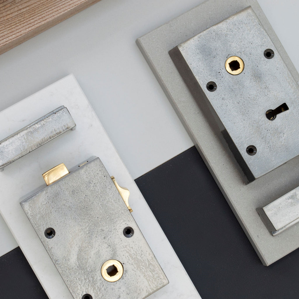 Ironmongery mood board with white, grey & navy backgrounds and 2 iron locks.