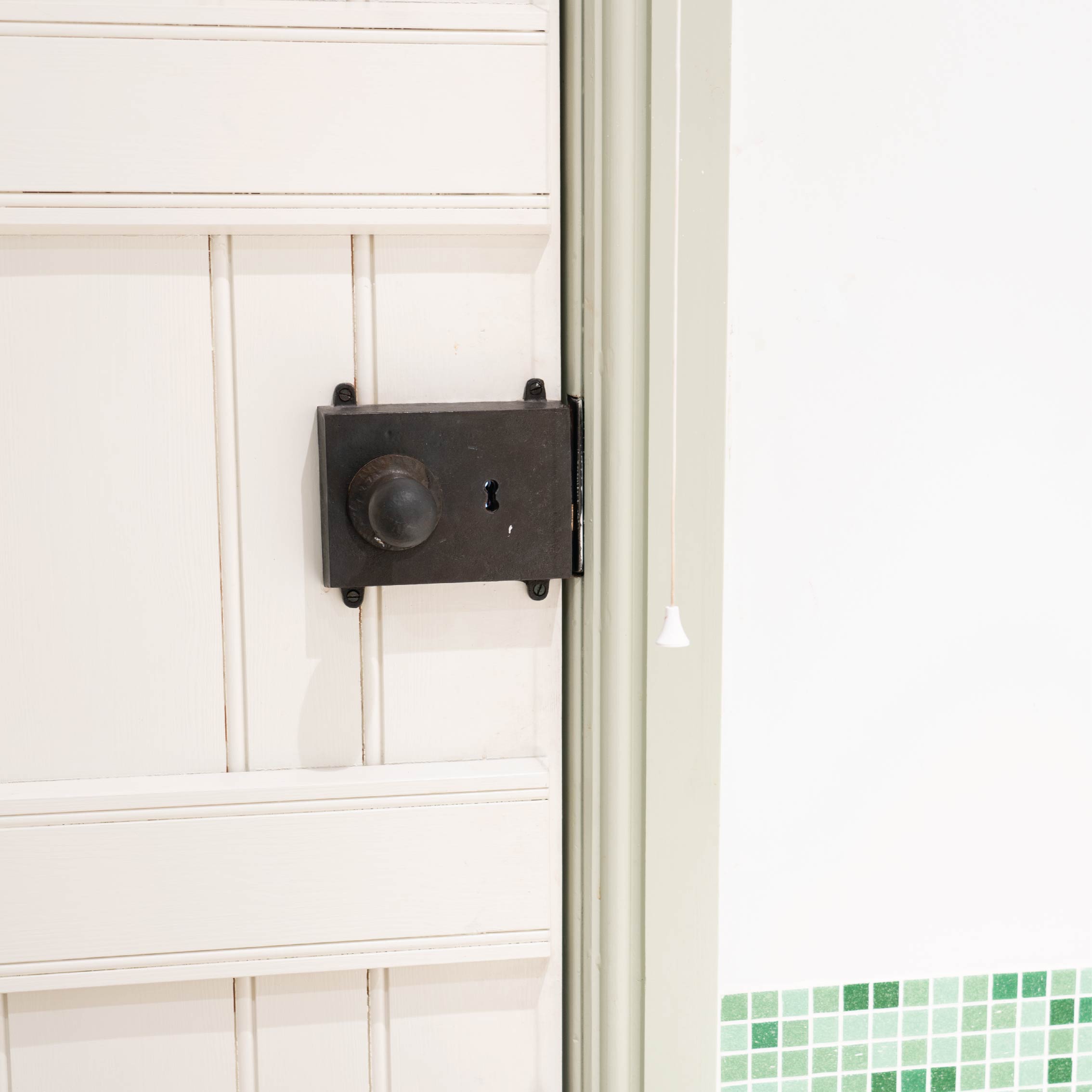 From The Anvil Beeswax rim door lock on a white painted ledge and brace door