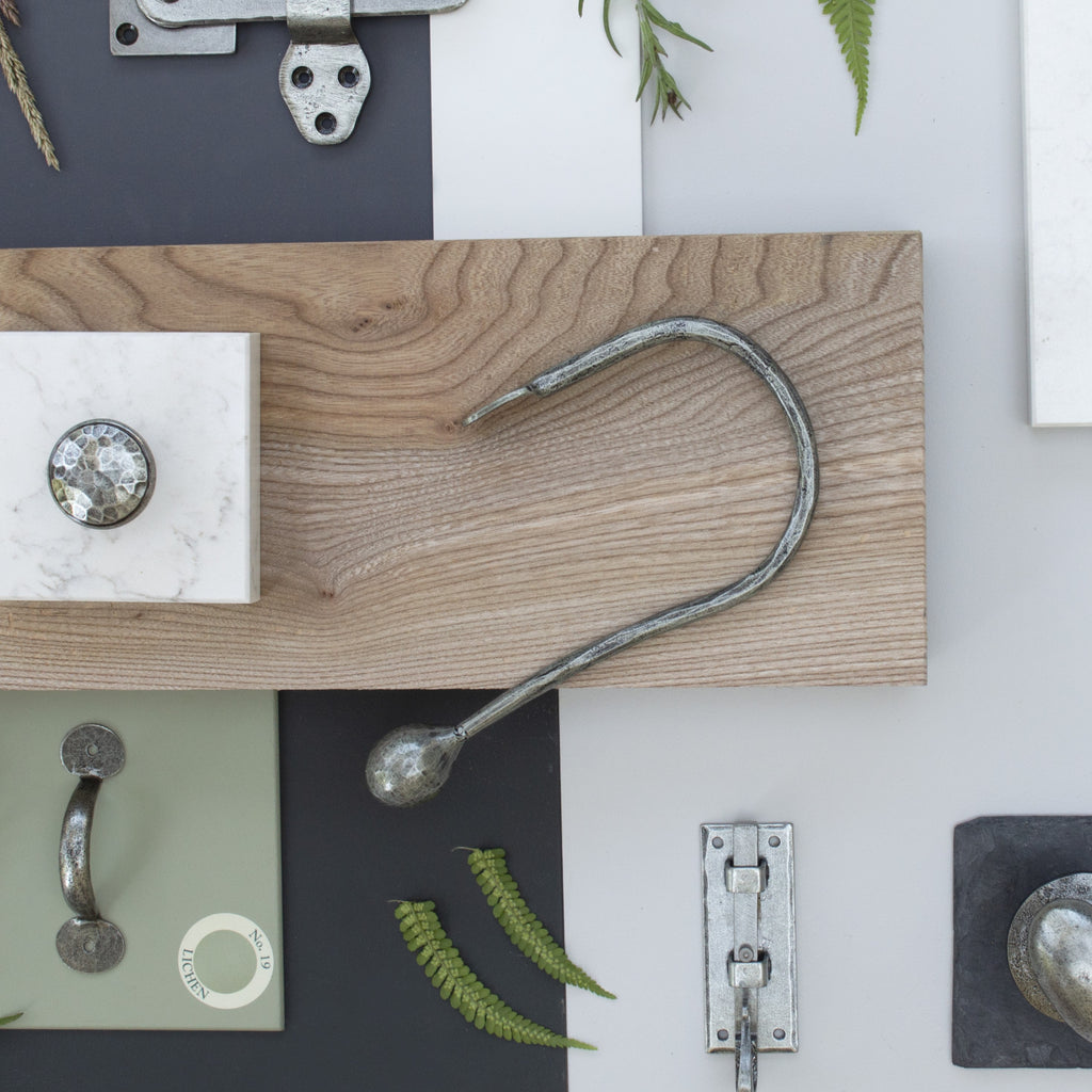 Moodboard of From The Anvil's Pewter hardware including wall hooks, pull handles, and cabinet knobs.