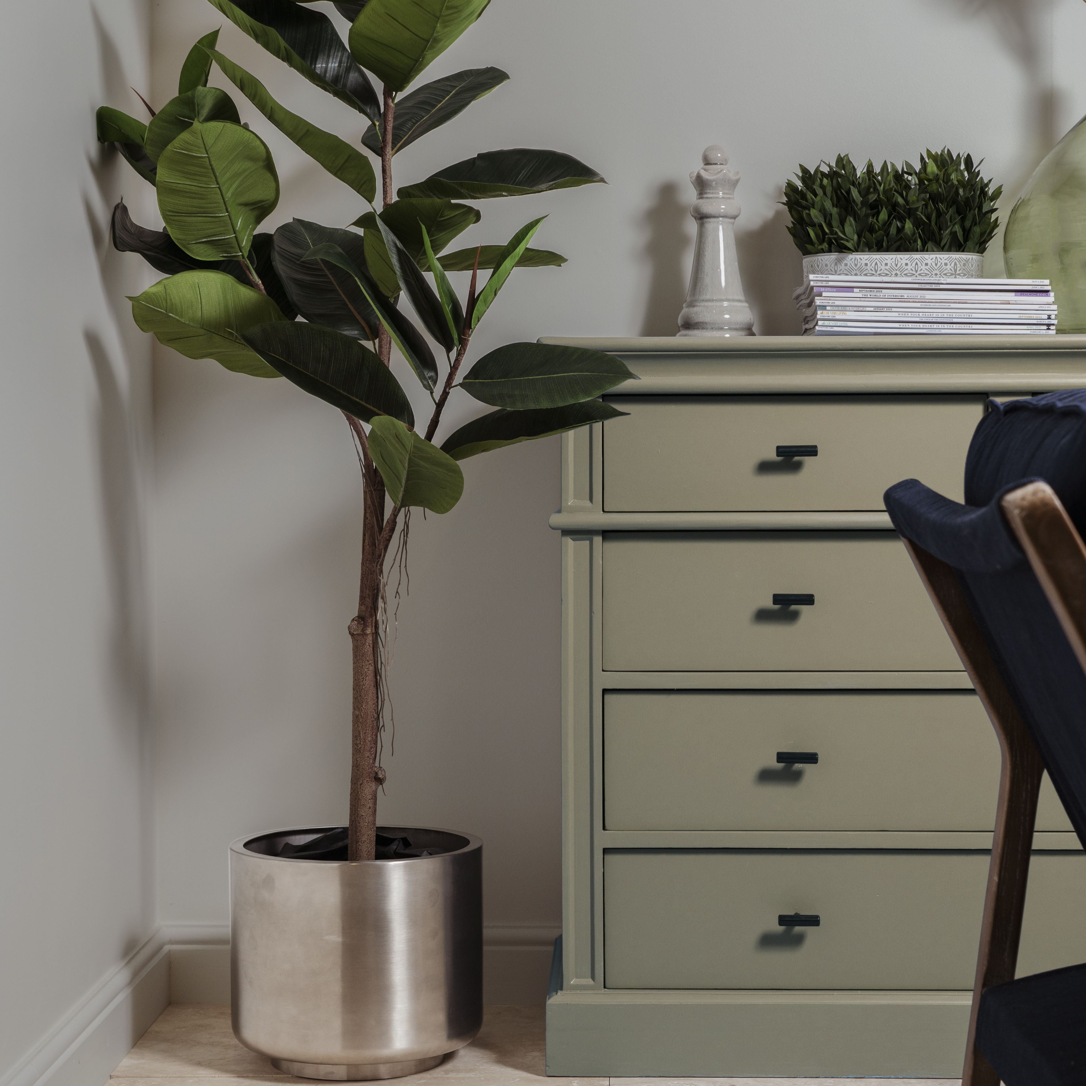 Satin Stainless Steel Newlyn contemporary plant pot next to a green shelf unit with From The Anvil T Bar cabinet handles.