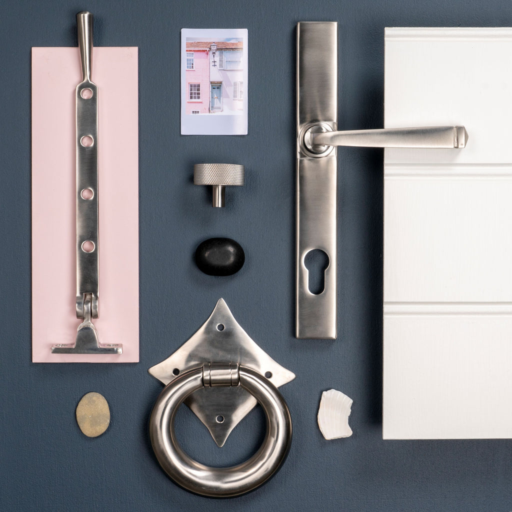 Moodboard of From The Anvil's Satin Stainless Steel door handles, door knockers, window stays, and cabinet knobs.