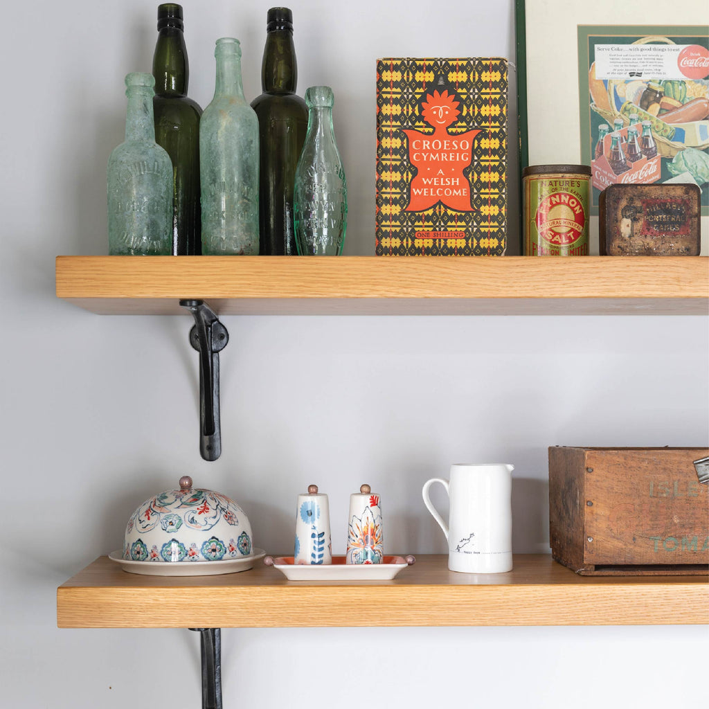 From The Anvil Black plain shelf brackets with wooden shelves filled with knick knacks