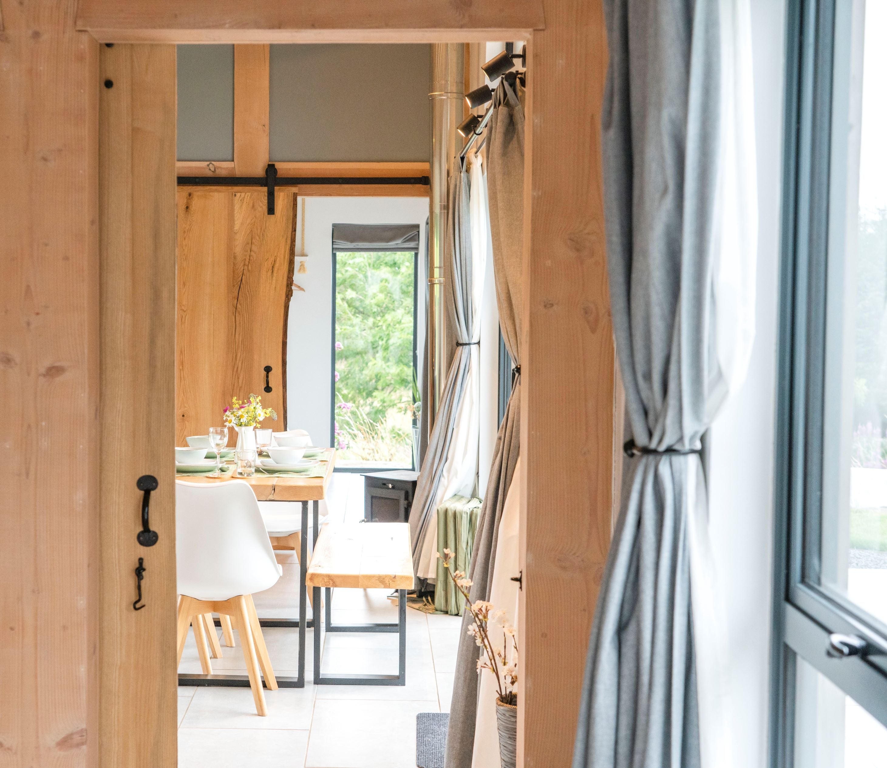 Sliding wooden door with From The Anvil's Black pull handle, hook, and Black sliding door kit.