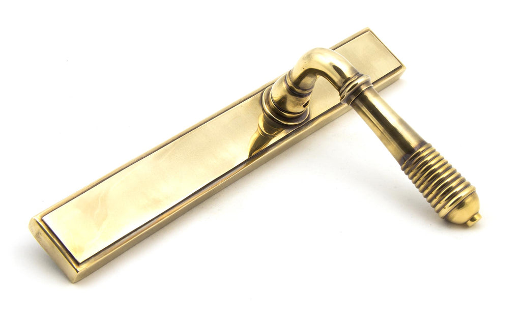 White background image of From The Anvil's Aged Brass Reeded Slimline Lever Espag. Latch Set | From The Anvil