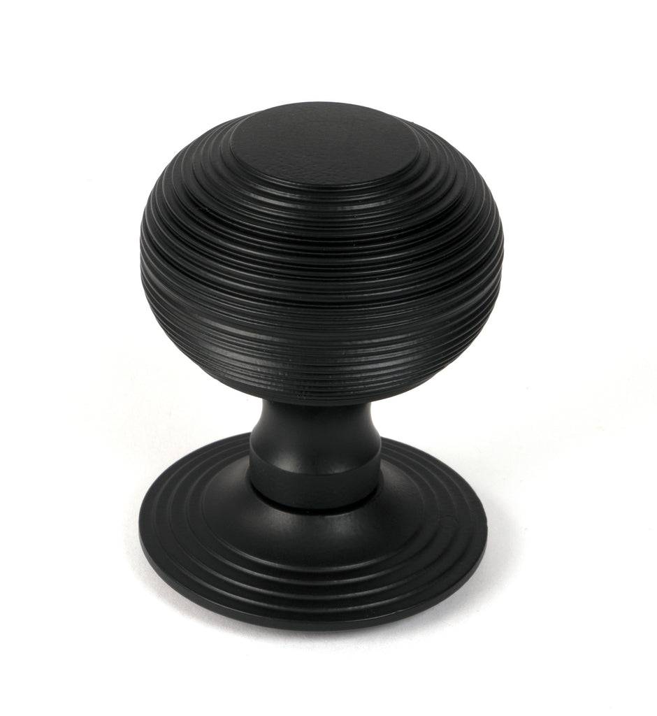 White background image of From The Anvil's Matt Black Beehive Centre Door Knob | From The Anvil