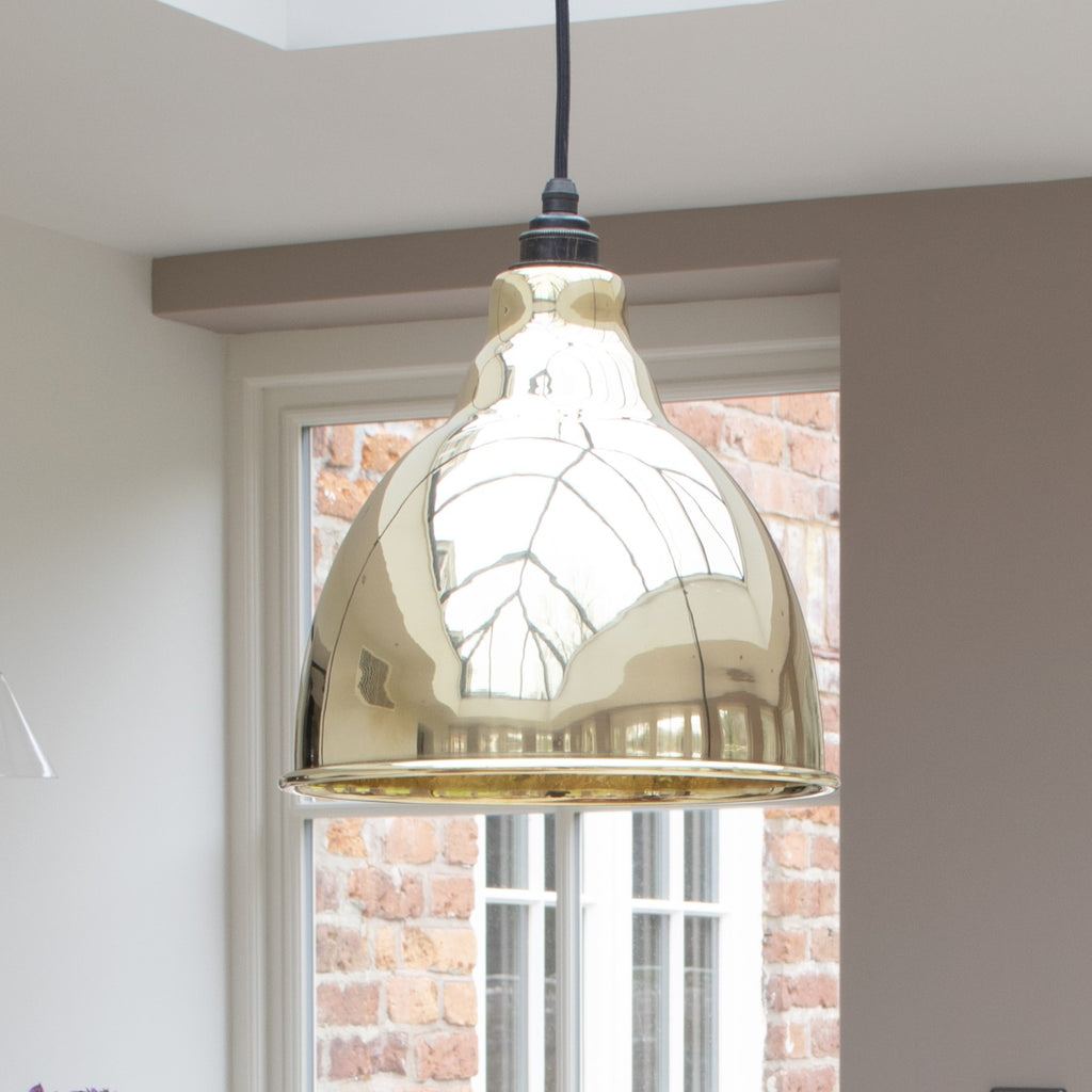Smooth Brass Brindley pendant hanging in a neutral conservatory.