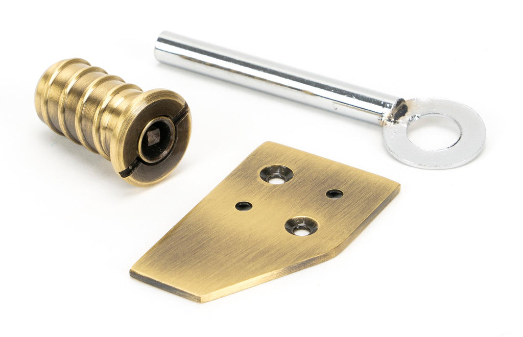 White background image of From The Anvil's Aged Brass Key-Flush Sash Stop | From The Anvil