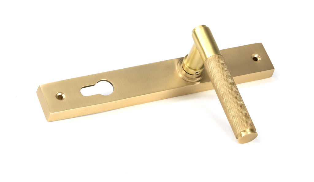 White background image of From The Anvil's Satin Brass Brompton Slimline Lever Espag. Lock Set | From The Anvil
