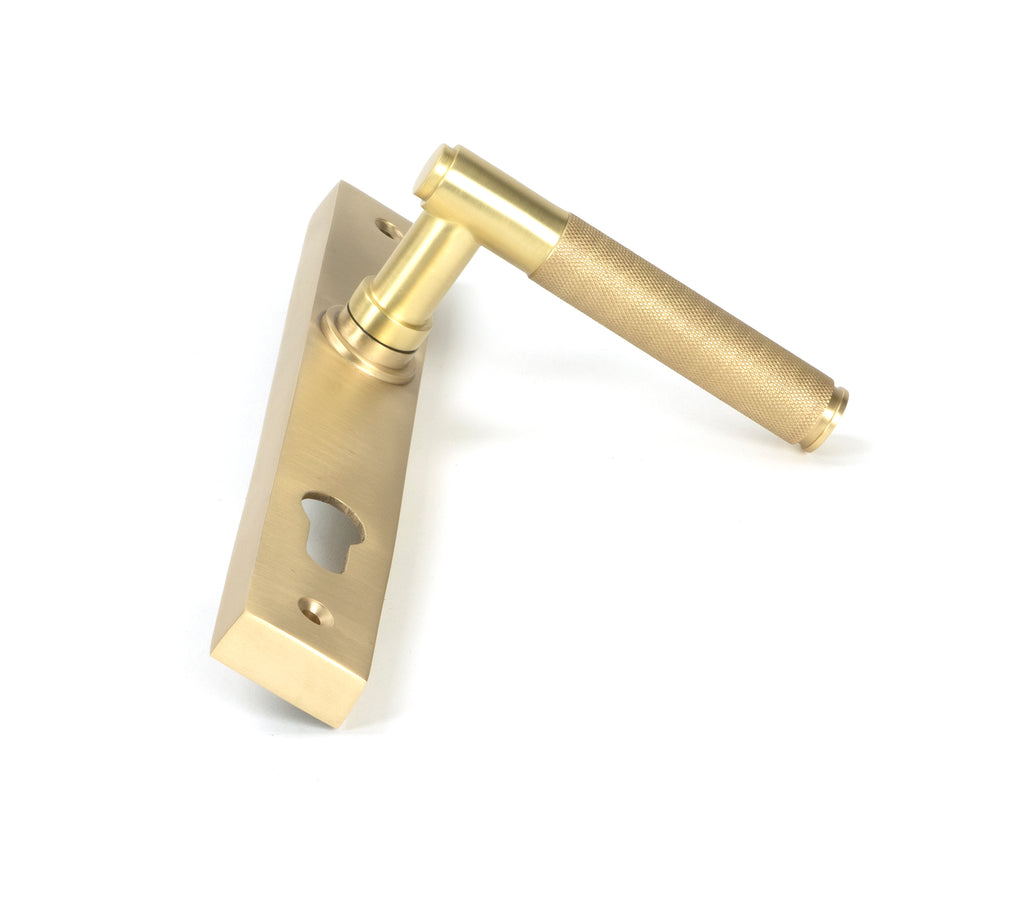 White background image of From The Anvil's Satin Brass Brompton Slimline Lever Espag. Lock Set | From The Anvil