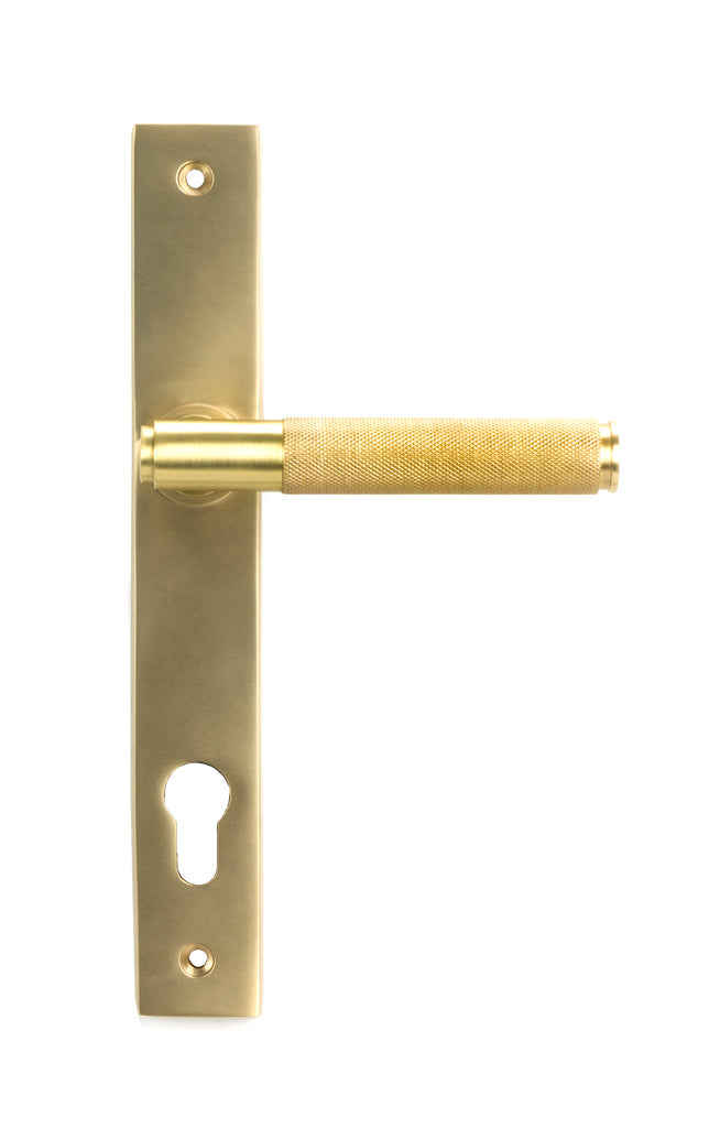 White background image of From The Anvil's Satin Brass Brompton Slimline Lever Espag. Lock Set | From The Anvil