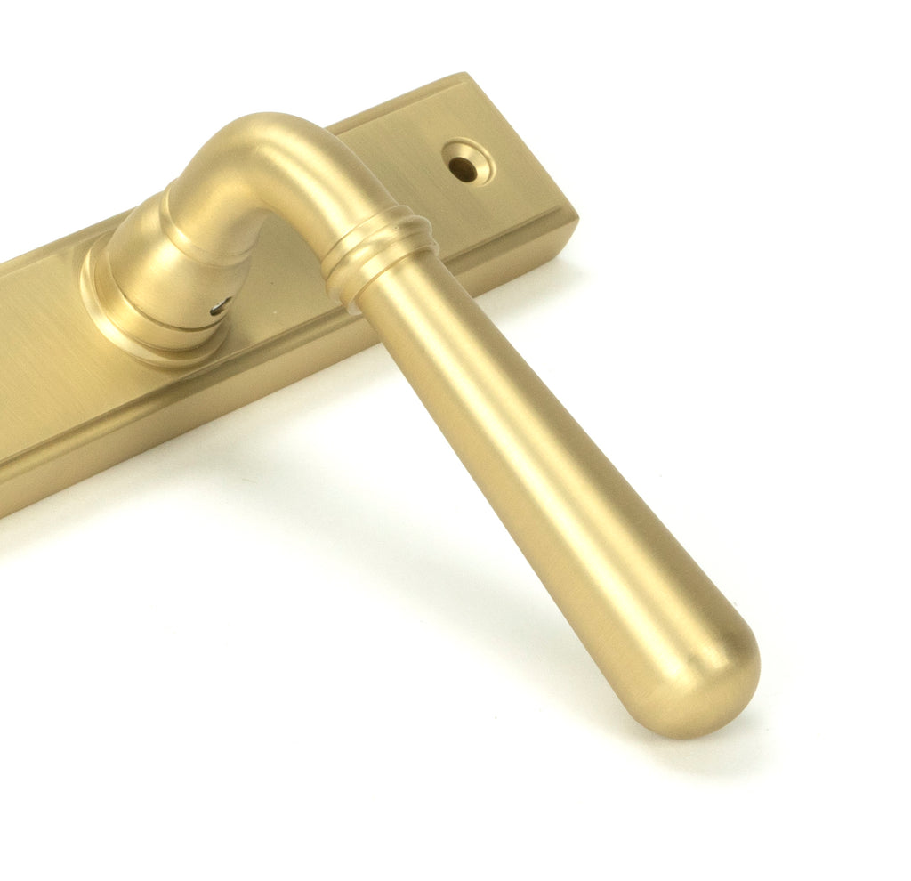 White background image of From The Anvil's Satin Brass Newbury Slimline Lever Espag. Lock Set | From The Anvil