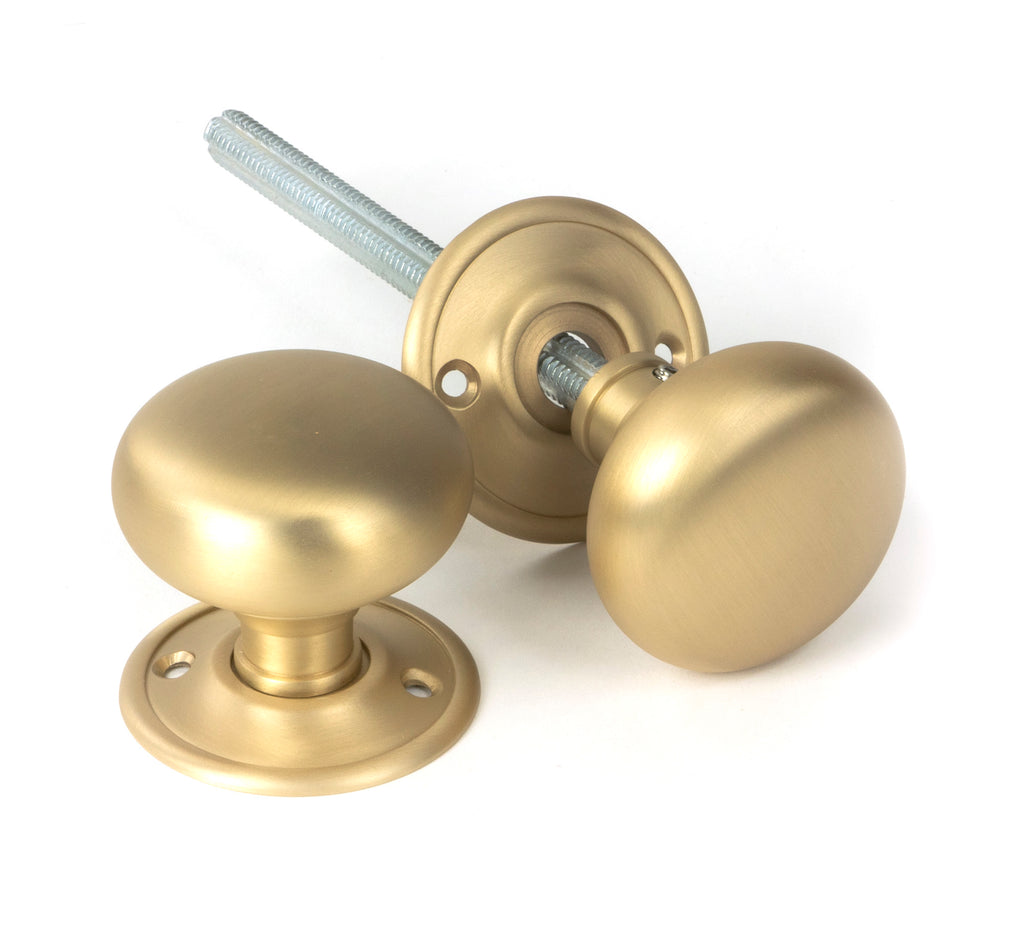 White background image of From The Anvil's Satin Brass Mushroom Mortice/Rim Knob Set | From The Anvil