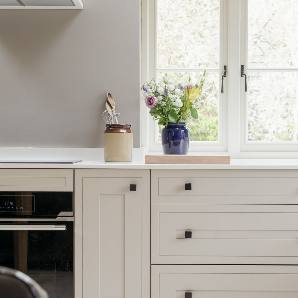 Cream kitchen with From The Anvil Square Cabinet knob pull handles.