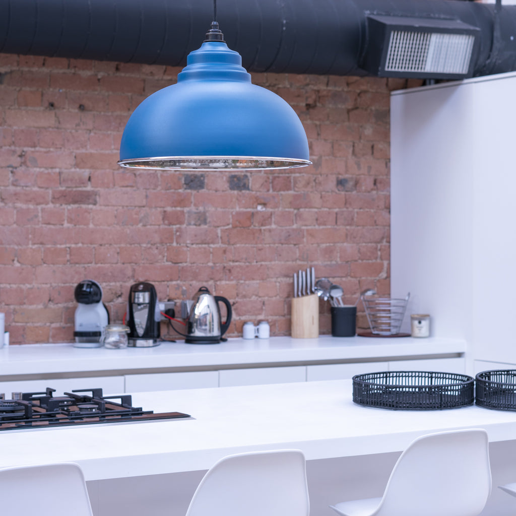 Bright blue Harborne From The Anvil Nickel ceiling pendant light in a contemporary kitchen.
