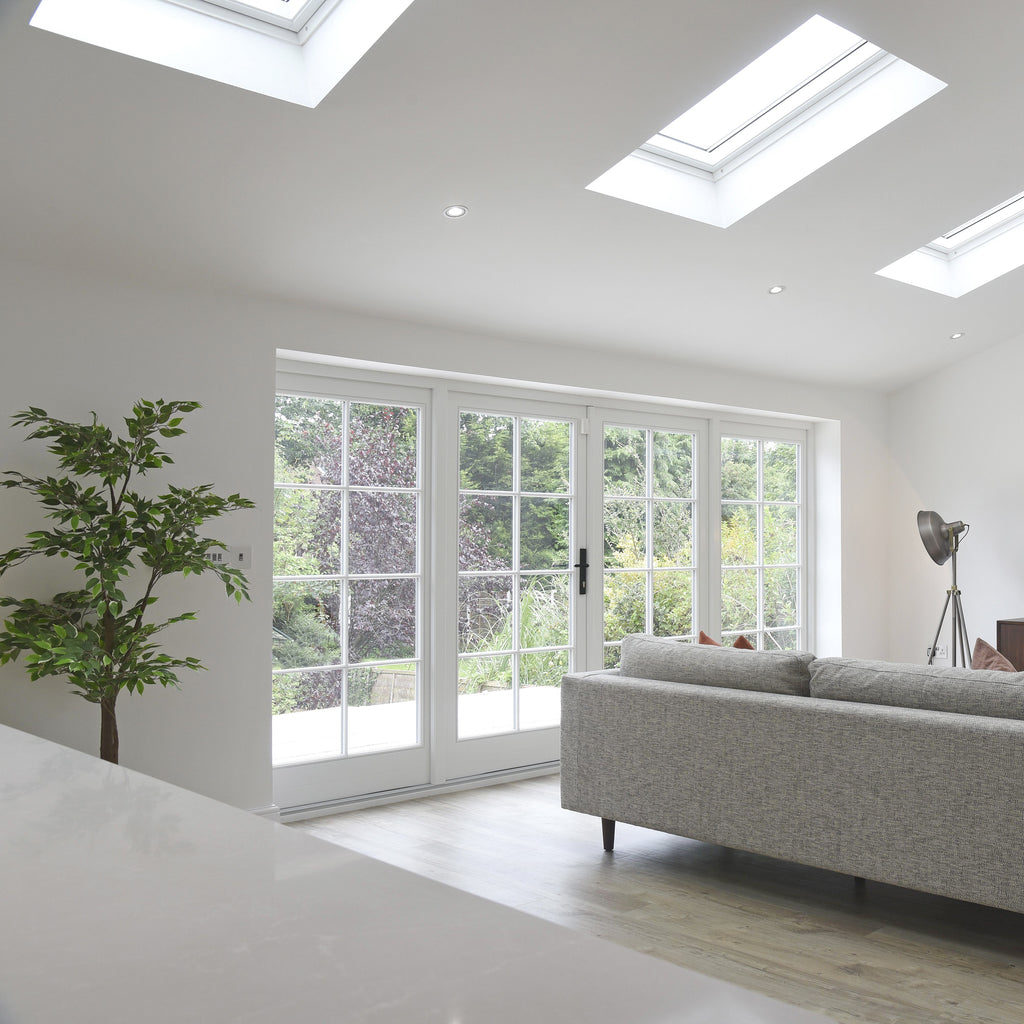 White living room with glazed patio doors fitted with a Black From The Anvil lever lock door handle.