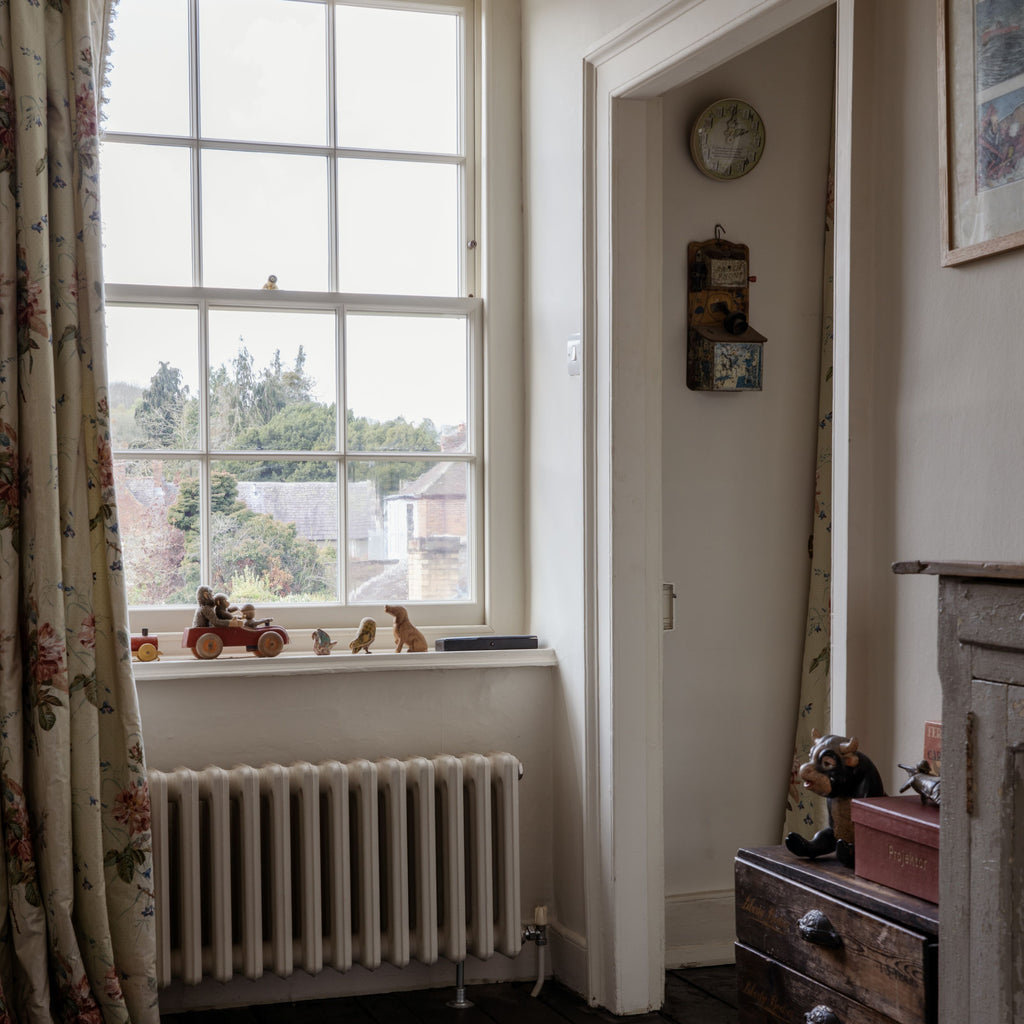 Vintage interior with white sash windows fitted with From The Anvil sash window hardware.