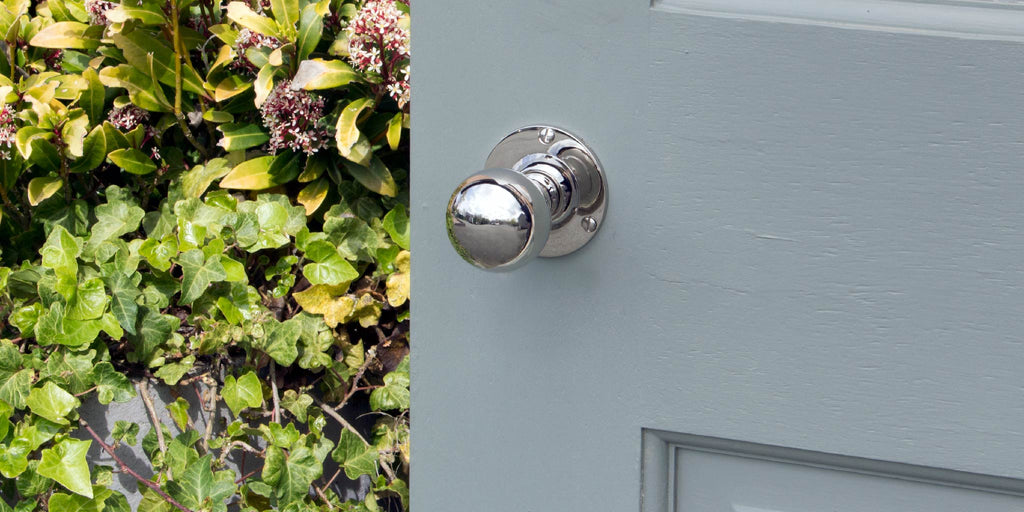 From The Anvil's Polished Chrome Round Door knob handle on a blue painted door.