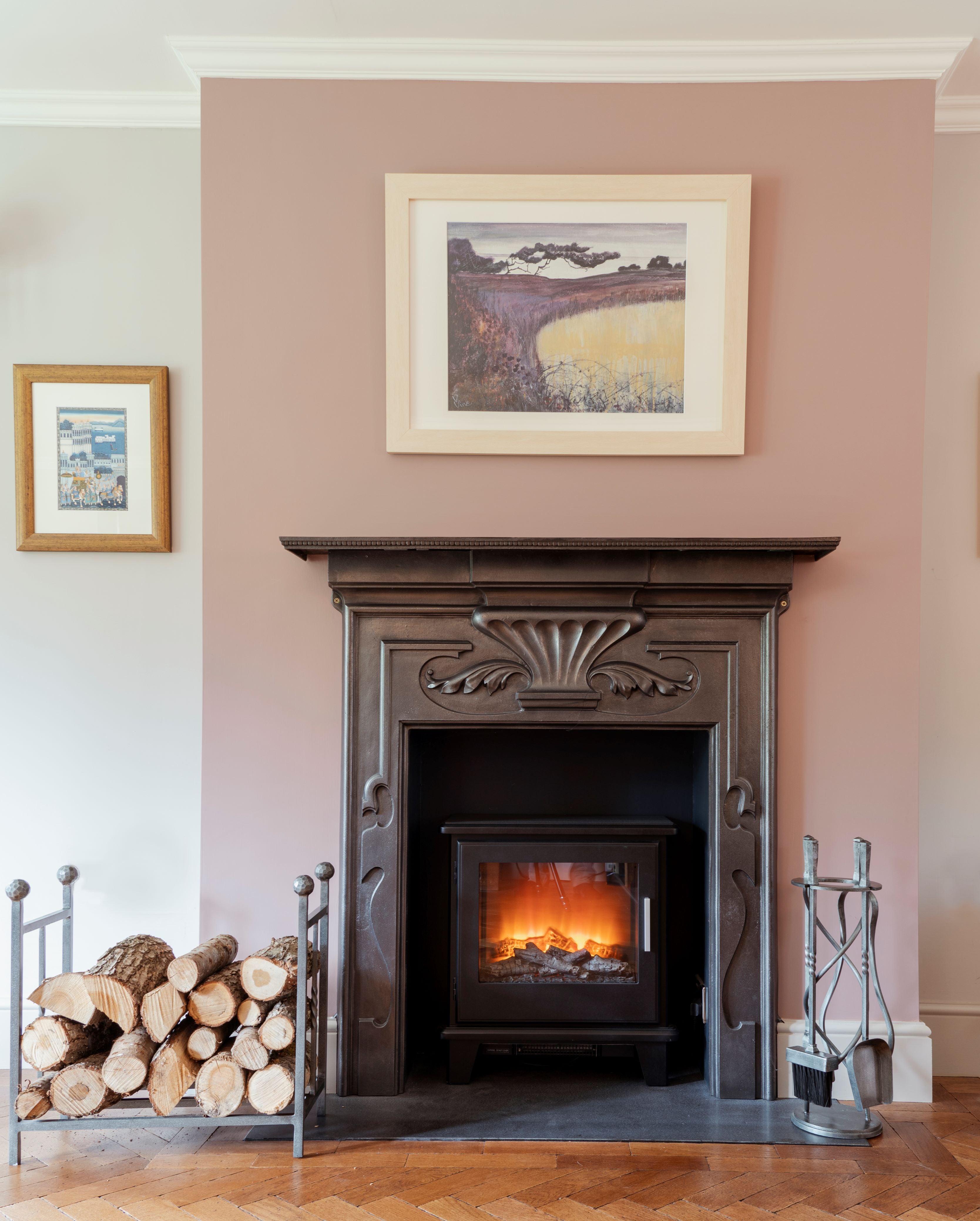 From The Anvil Pewter Rectangular log holder and matching Spiral companion set in front of a lit log burner.