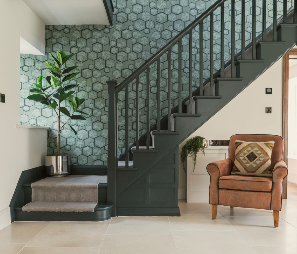From The Anvil Stainless Steel plant pots on a dark painted staircase in a stylish interior.