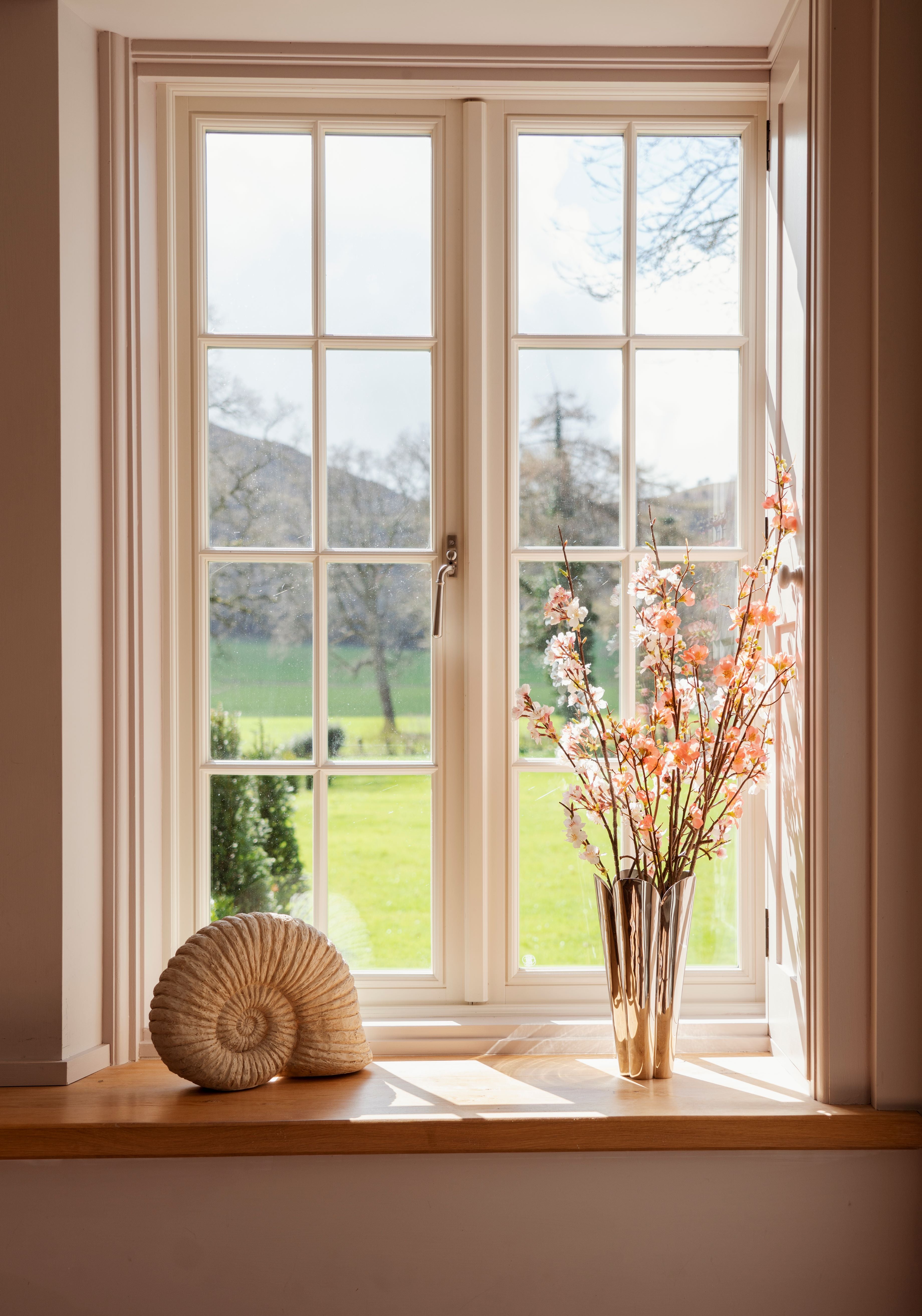 From The Anvil Polished Chrome window handle and Stainless Steel Flora vase.