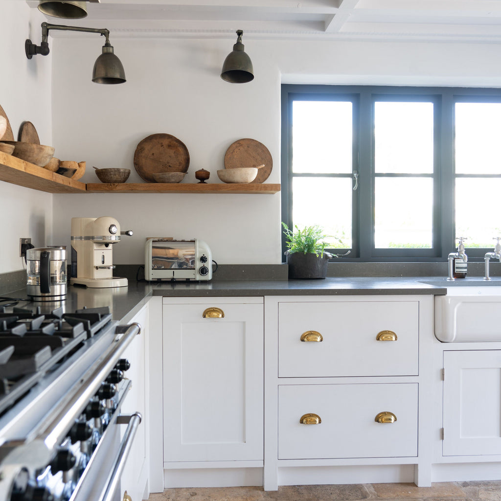 White and grey kitchen with Brass From The Anvil drawer pull handles
