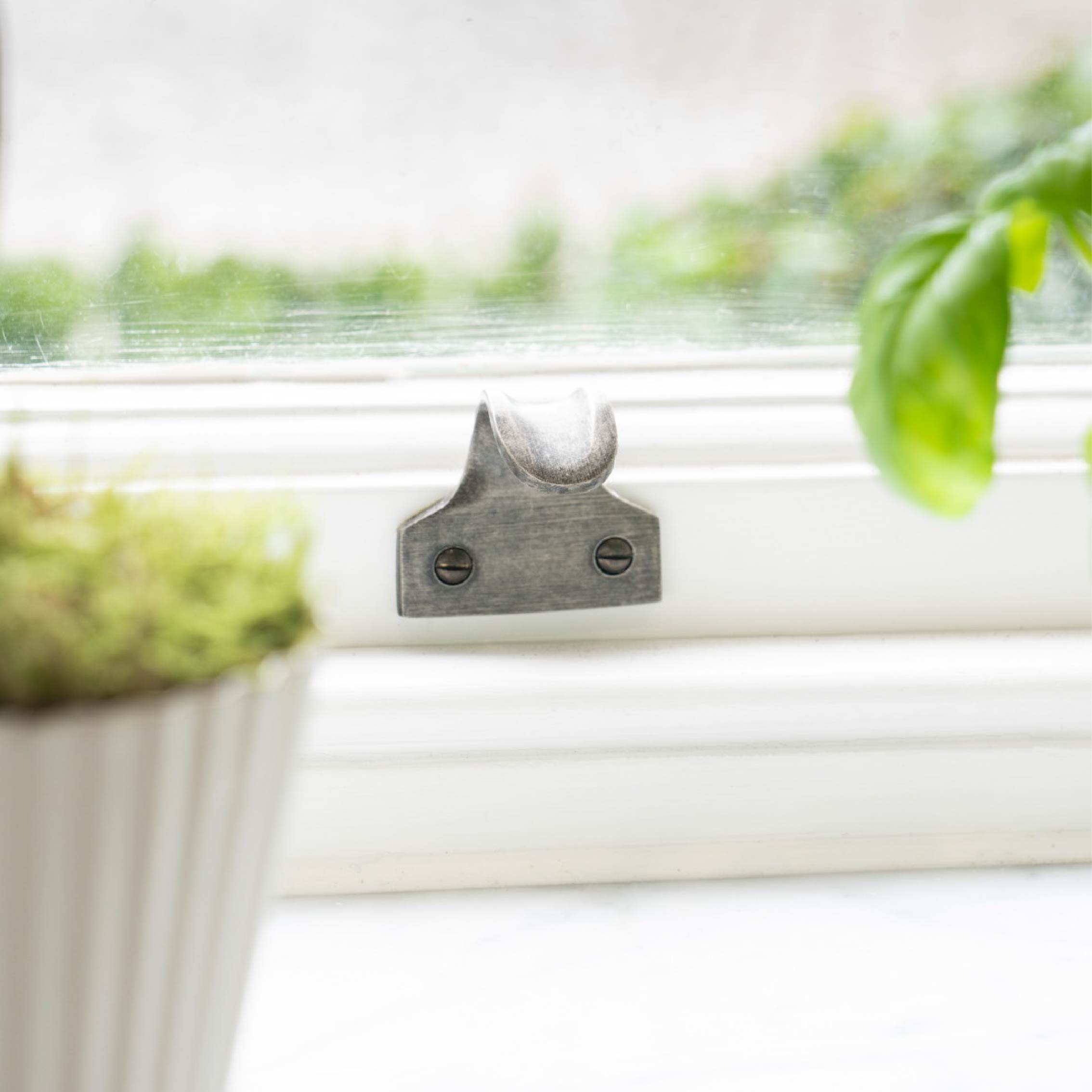 From The Anvil's Pewter Sash window hardware lift on a white window frame